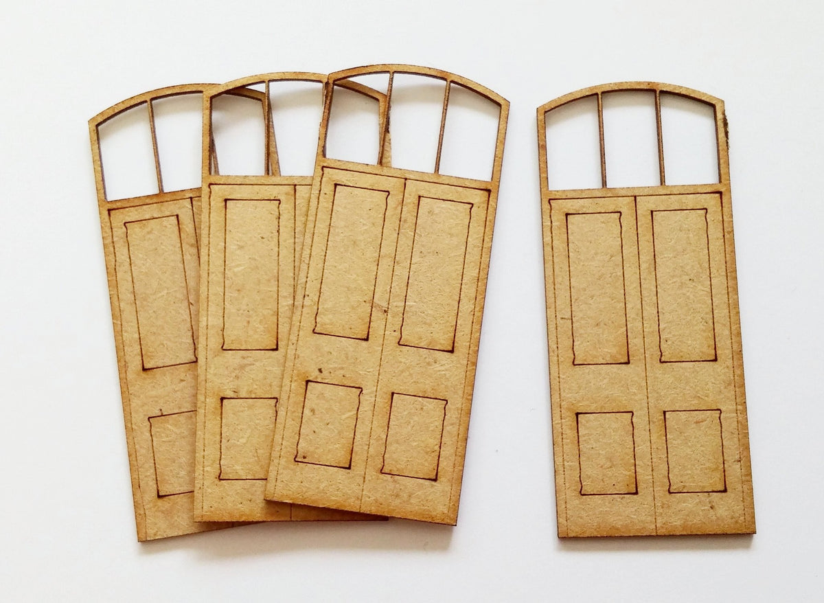 Four laser cut model train doors made from light brown material, with etched panels and top lights, displayed against a white background.