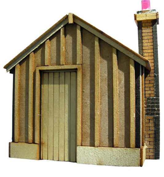 A laser cut and engraved MDF kit of a platelayers hut with a Apex Roof, designed for model train sets, showing the hut's exterior with timbers and a chimney.
