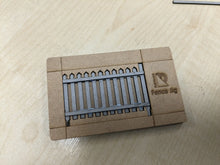 Load image into Gallery viewer, A greyboard fencing kit for model railroads, showing the back runners 