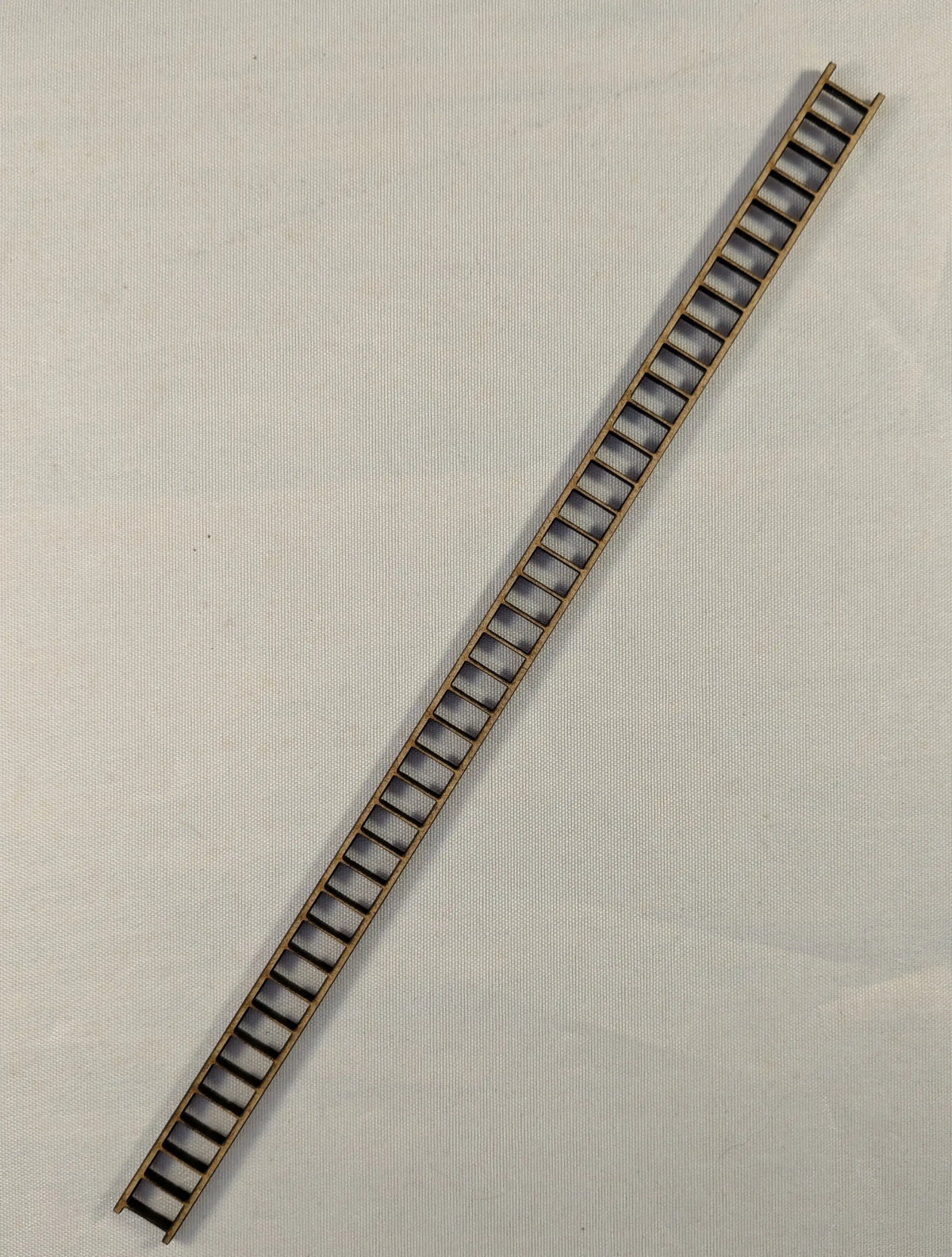 The ladder is 200mm long x 10mm wide, the MDF is easy to cut with a good craft knife.