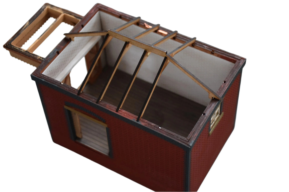 Rail Model Rhoystellen Station Goods Shed, 4 mm scale—partially roofed model showing detailed internal structure with exposed roof trusses, timber rafters, white interior walls, and arched loading doors.