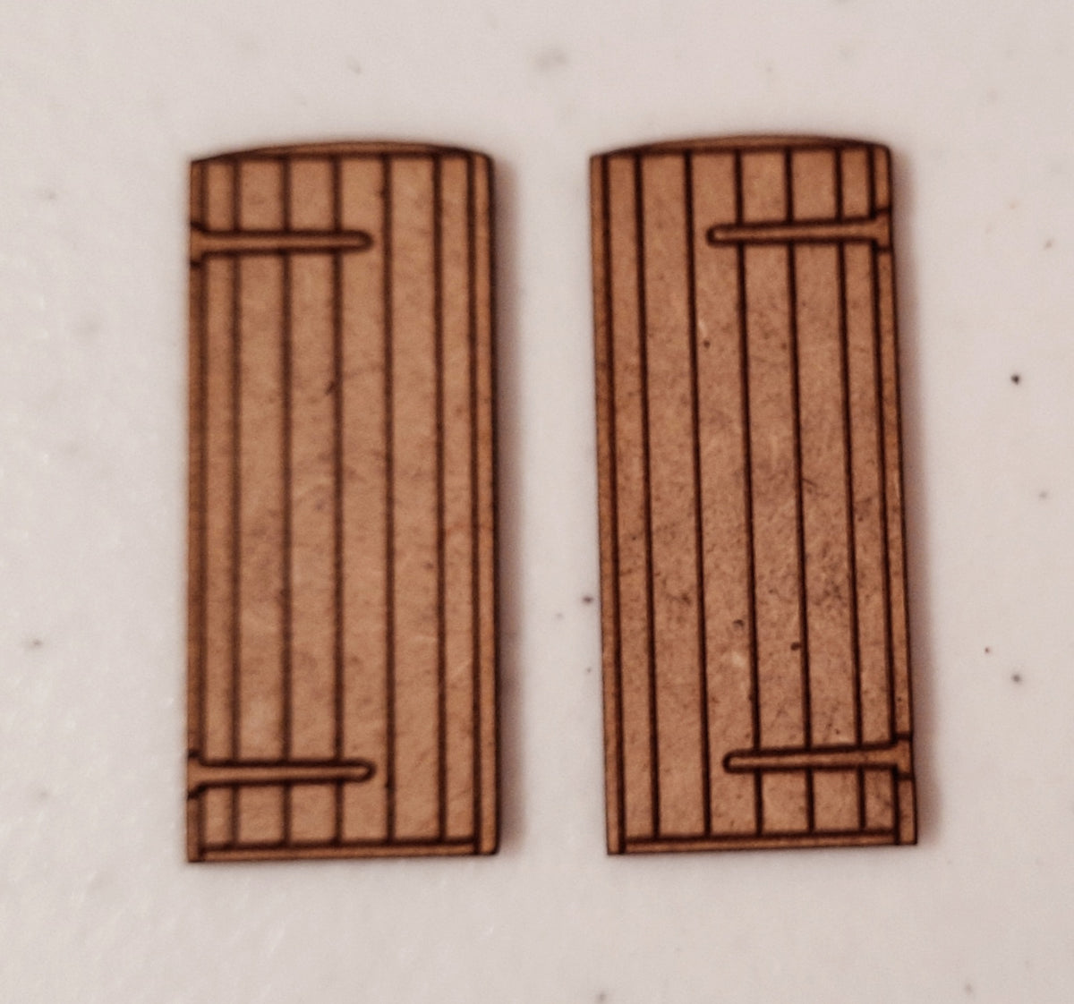 Two wooden panel style doors made from laser cut MDF, displayed on a white background.
