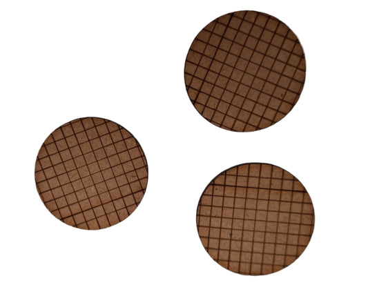 Three round model figure bases with an etched grid design, made from a brown MDF material.
