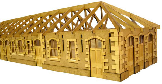 A laser cut and engraved wooden model kit resembling a railway station with detailed architecture.