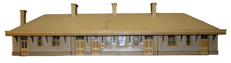A scale model kit of Helston Railway Station made from laser etched MDF, featuring window film, gutter, downpipe, and tiles.