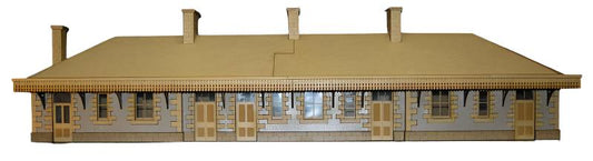 A scale model kit of Helston Railway Station made from laser etched MDF, featuring window film, gutter, downpipe, and tiles.