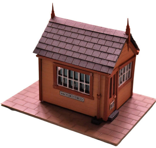 A model building with roof tiles made from grey slate card, depicting a small house or shed typically used in model train setups.